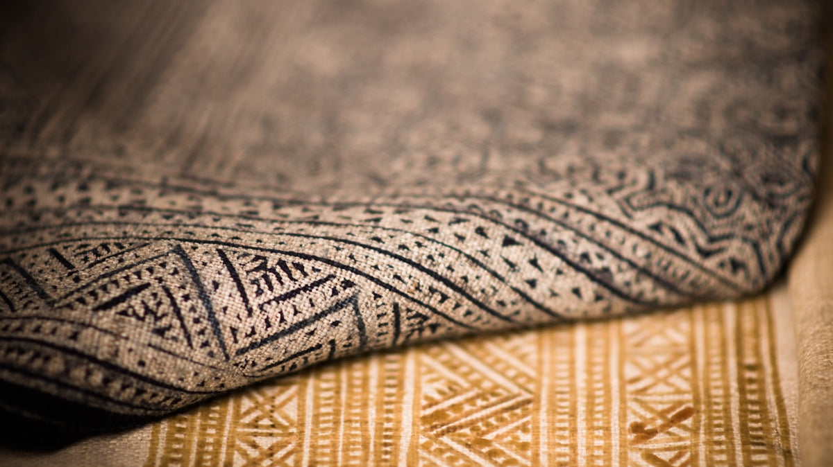 A close up that shows the texture of two different patterned rugs