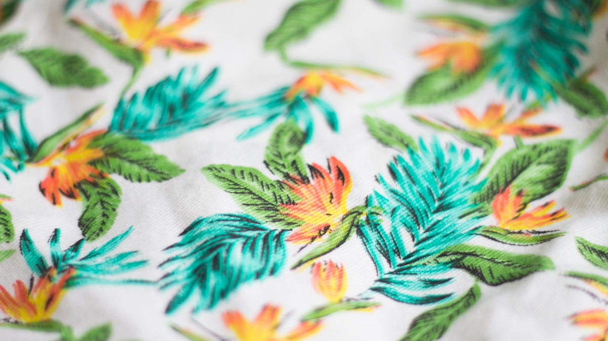 white, green, and teal floral textile