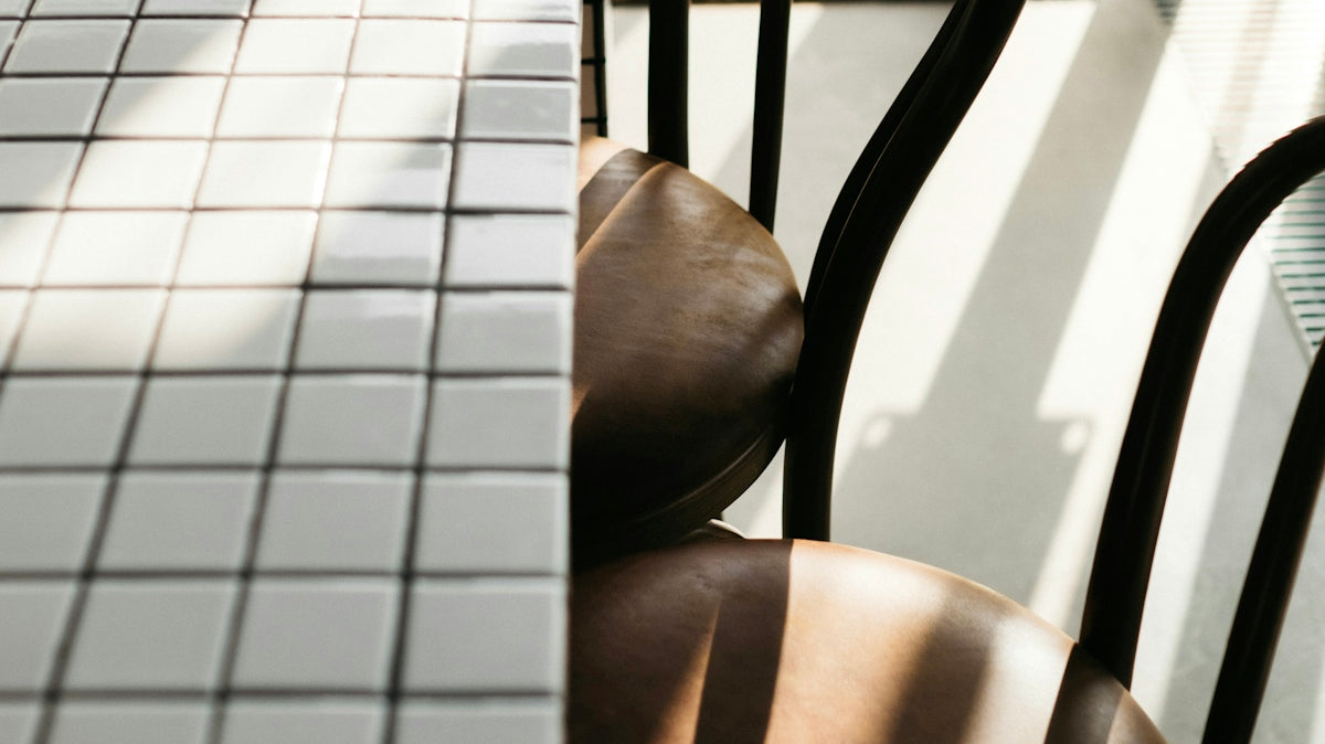 closeup photo of rectangular white table and two chairs