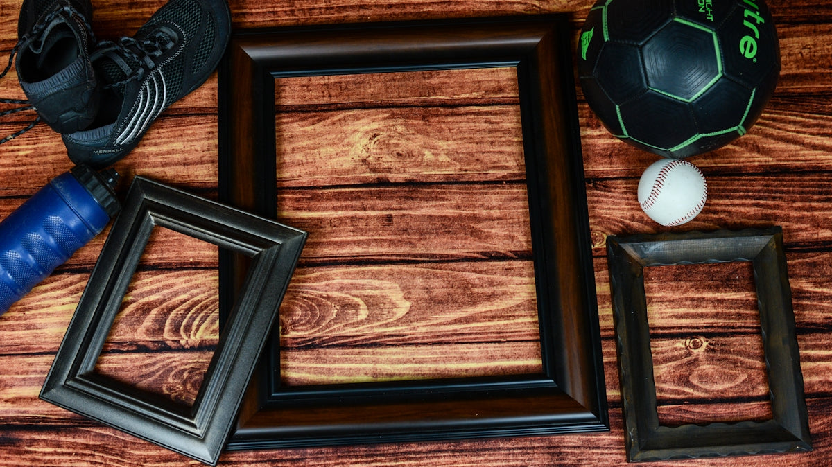 three rectangular black and brown photo frames on brown surface