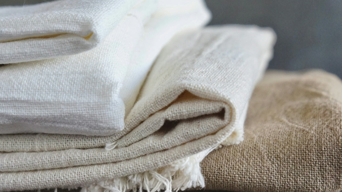 white textile on brown wooden table