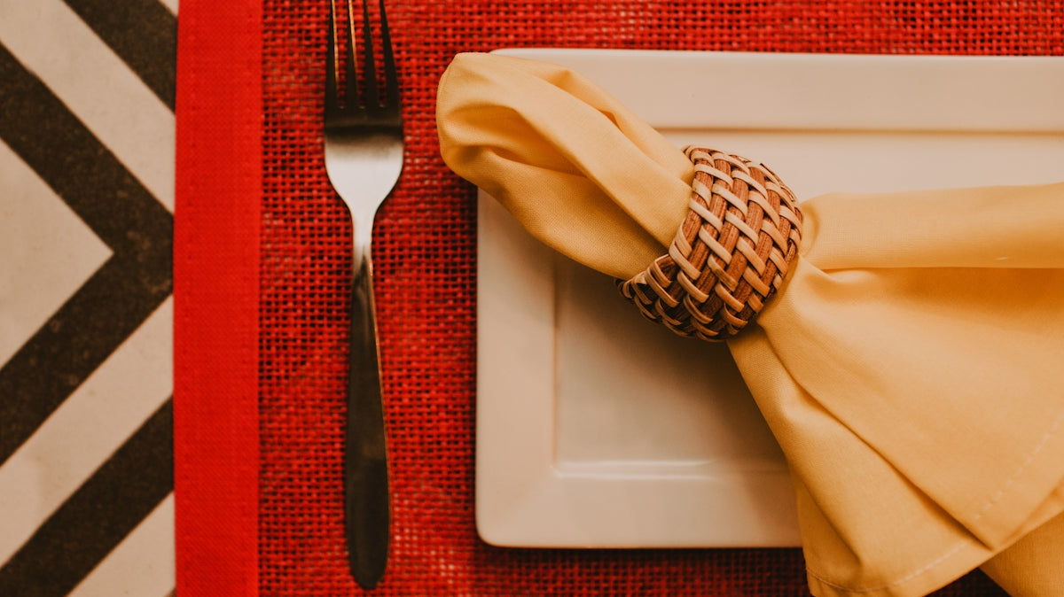 stainless steel fork and bread knife on white ceramic plate
