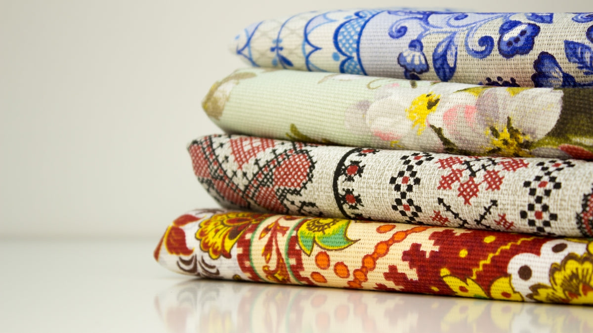 a stack of different colored fabrics sitting on top of each other