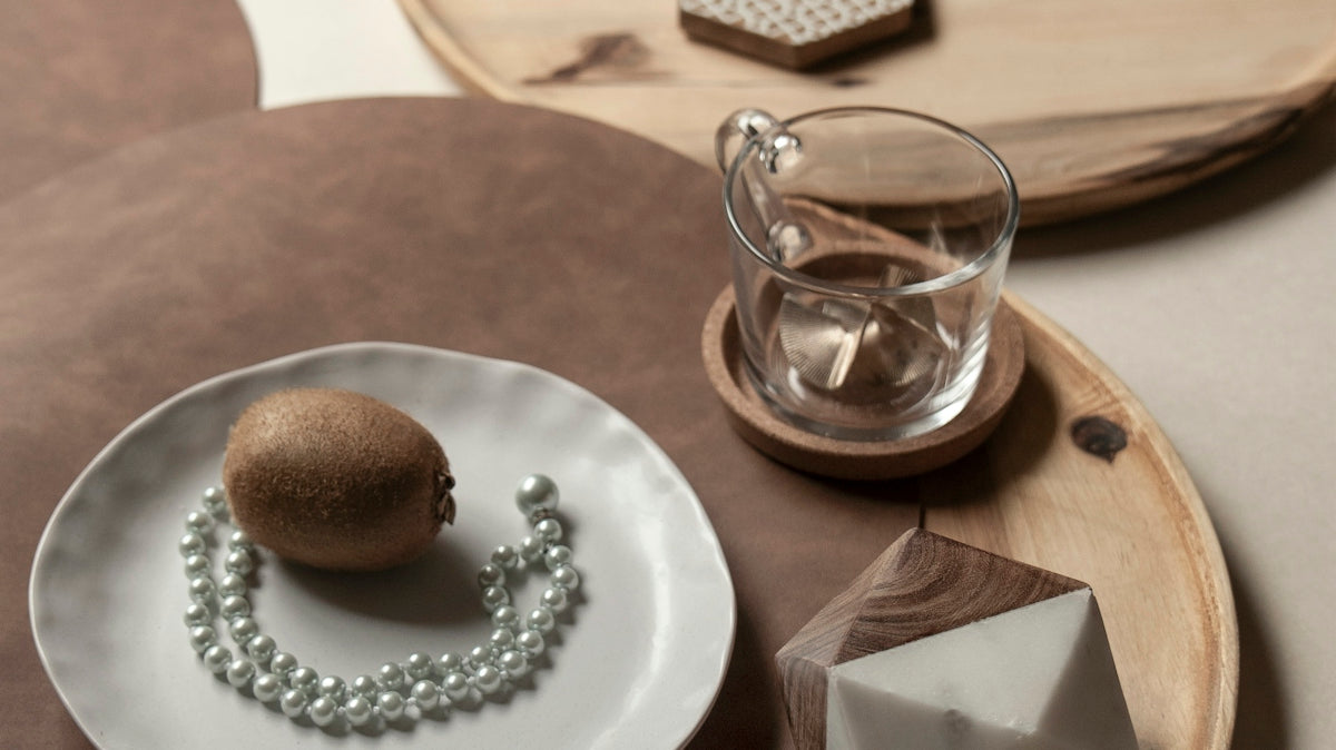 brown bread on white ceramic plate beside clear drinking glass on brown wooden table