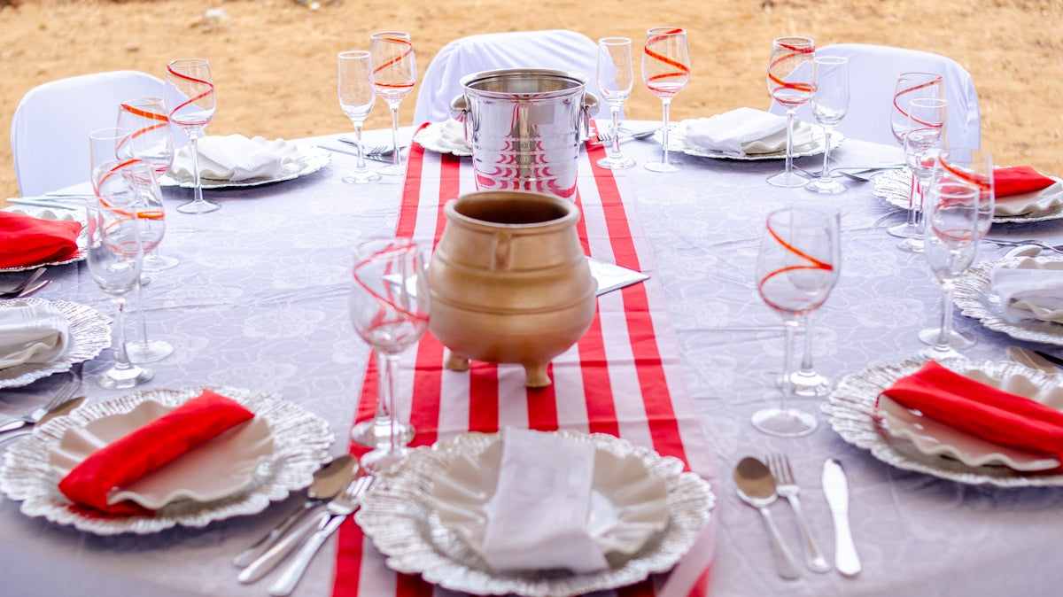 stainless steel fork and bread knife on white and red checkered table cloth