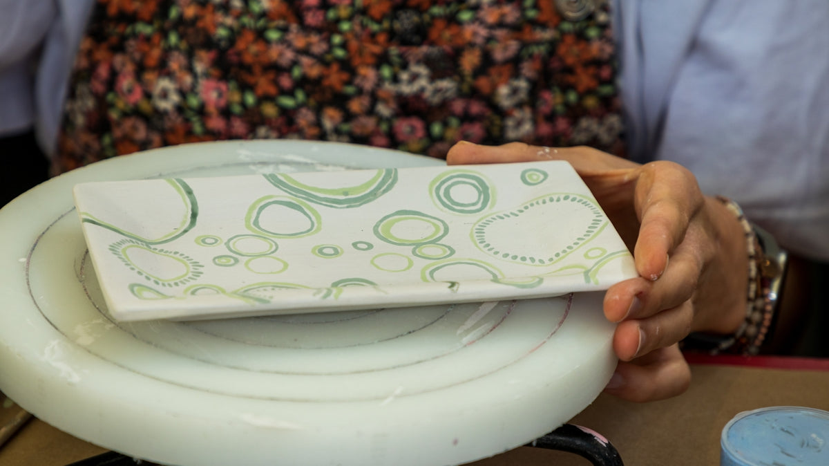 Ceramic Serving Plate with Green Bubble Design held by a person.