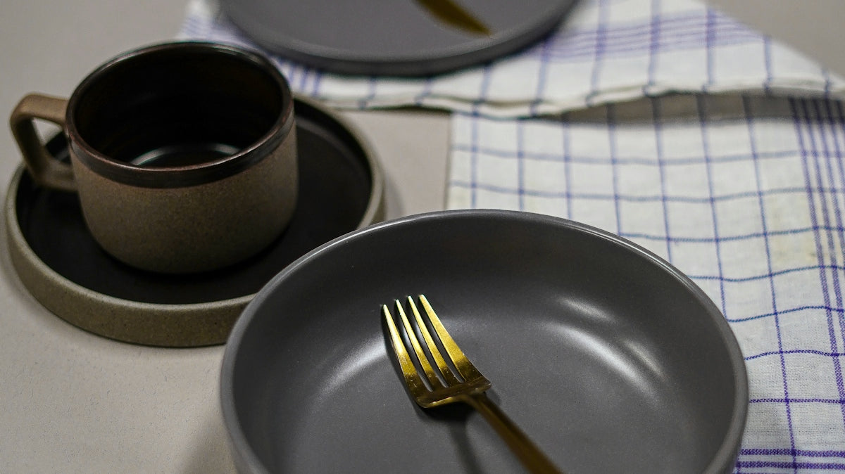 a plate with a cup and a spoon on it
