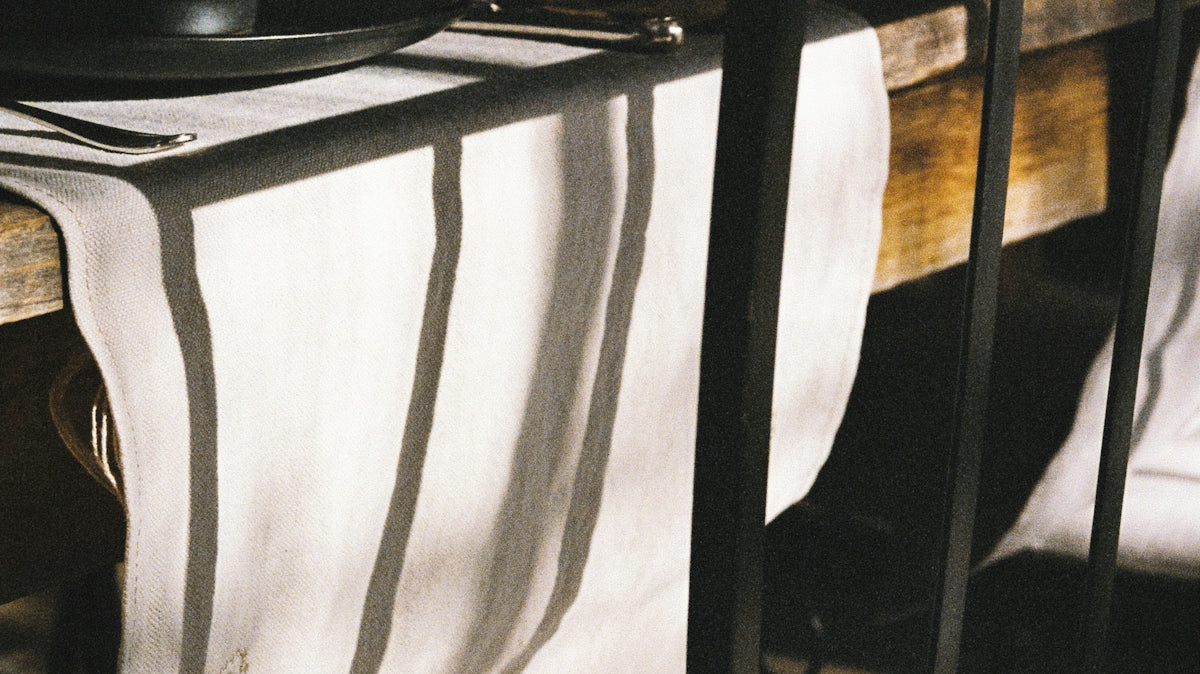a table with a chair and a table cloth on it