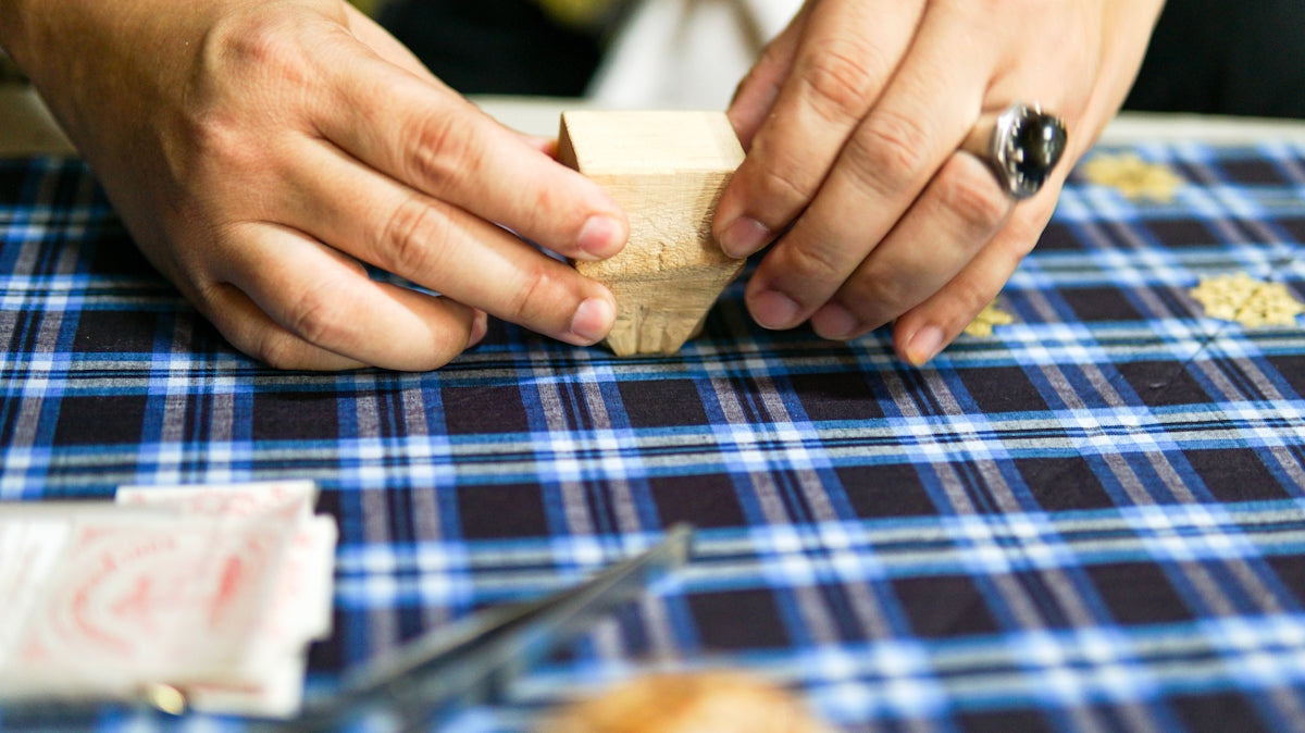 a close up of a person carving a piece of wood