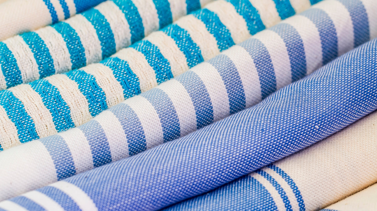 a group of blue and white striped fabrics