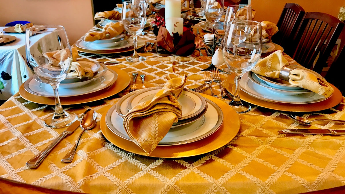 a table set for a formal dinner with plates and silverware