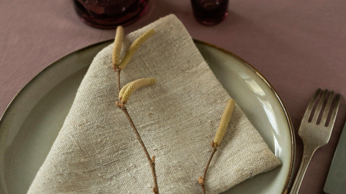 a place setting with a napkin, fork and knife