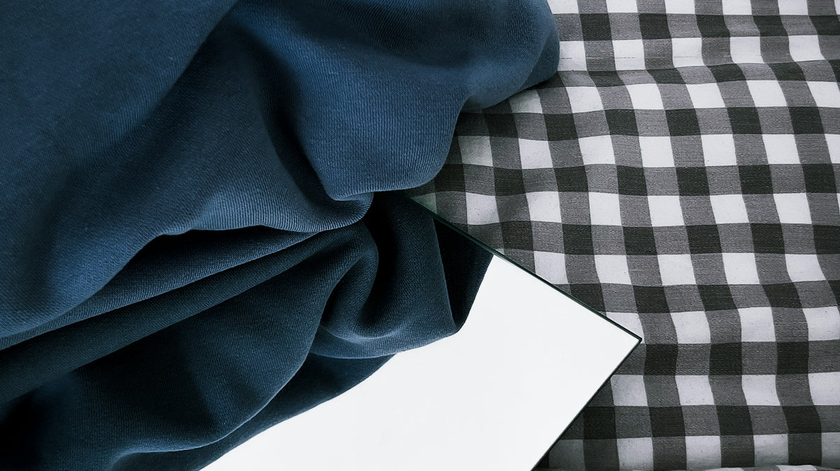 a black and white checkered bed spread with a white sheet