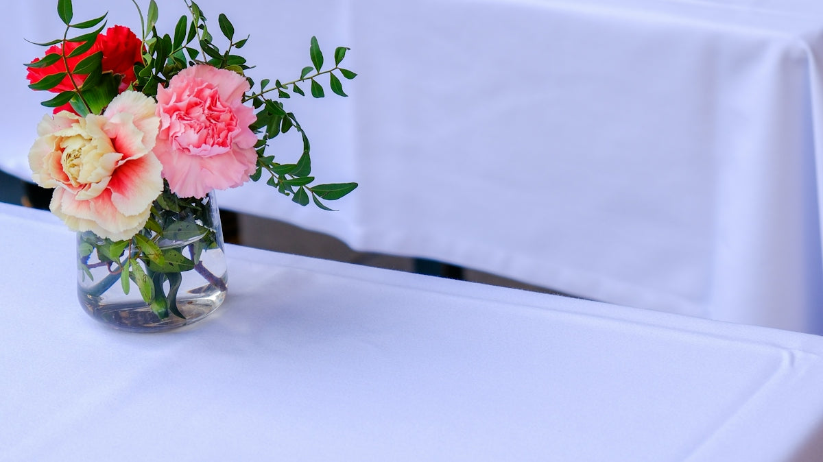 a table with two vases of flowers on top of it