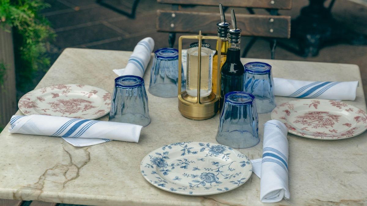 a table with plates and napkins on it