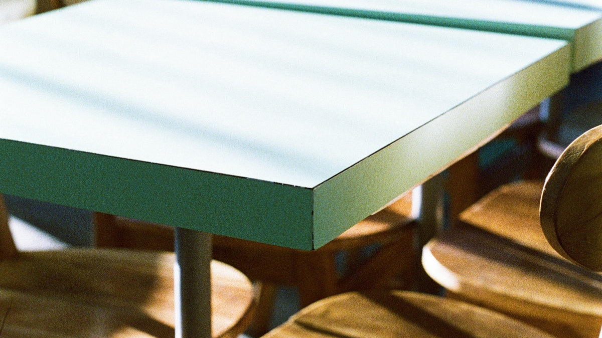 A group of wooden chairs sitting next to each other