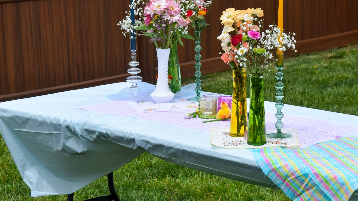 A table topped with vases filled with flowers
