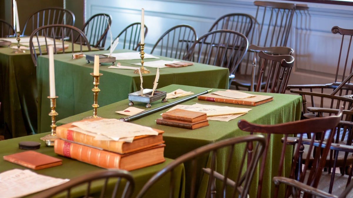 A table with many books and candles on it
