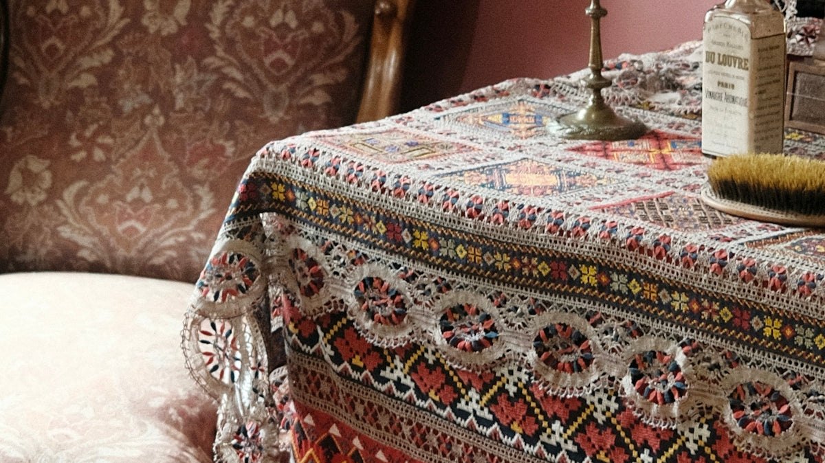 A chair and decorated table are in a room.