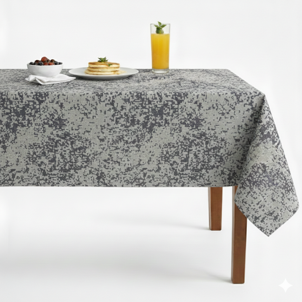 Textured gray tablecloth featuring a speckled design, perfect for dining settings.