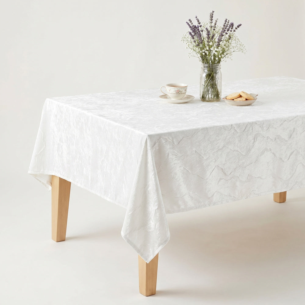 White Lace Tablecloth elegantly draped over a wooden table with a vase of lavender and snacks.