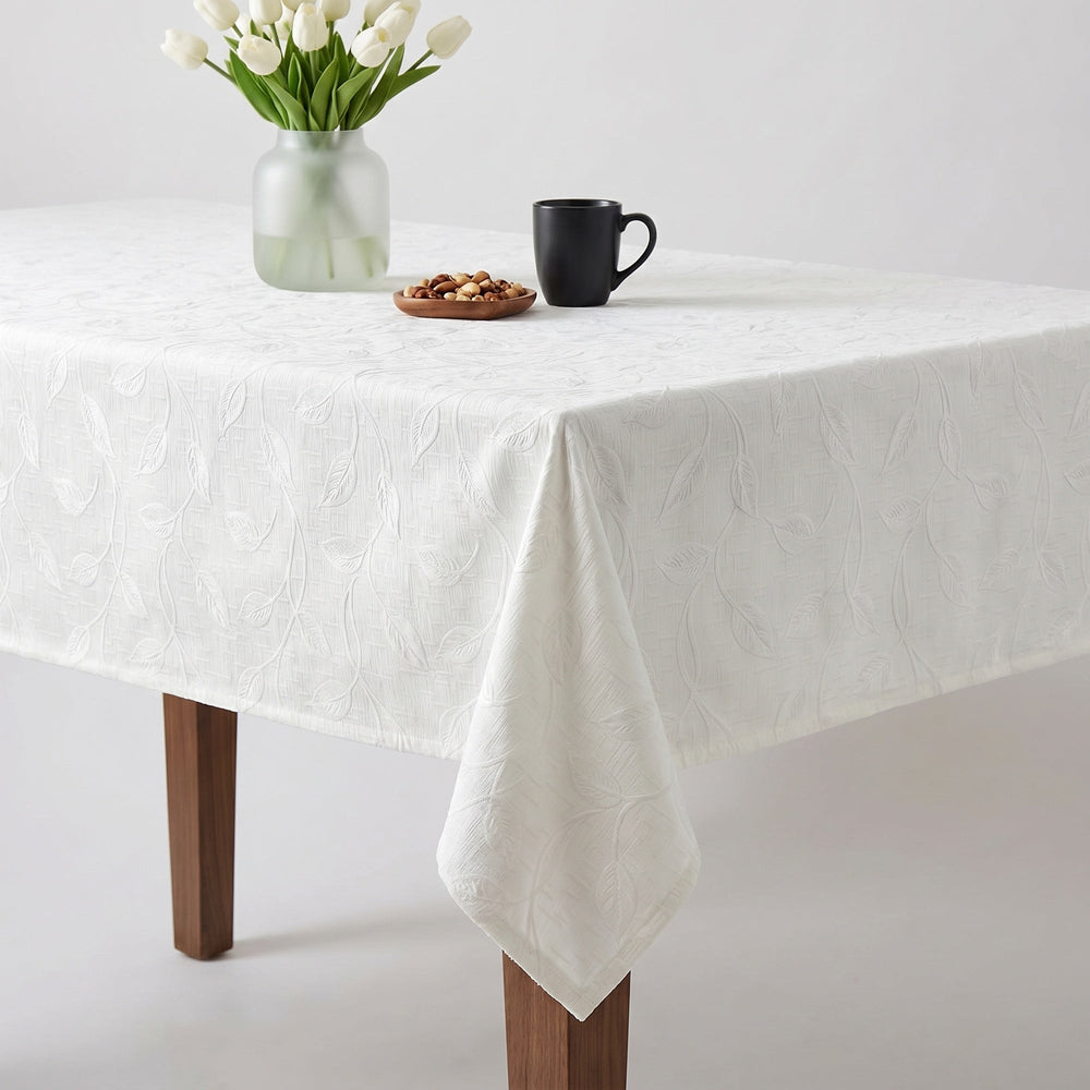 White Tablecloth featuring elegant texture, enhancing dining experience with flowers and snacks.