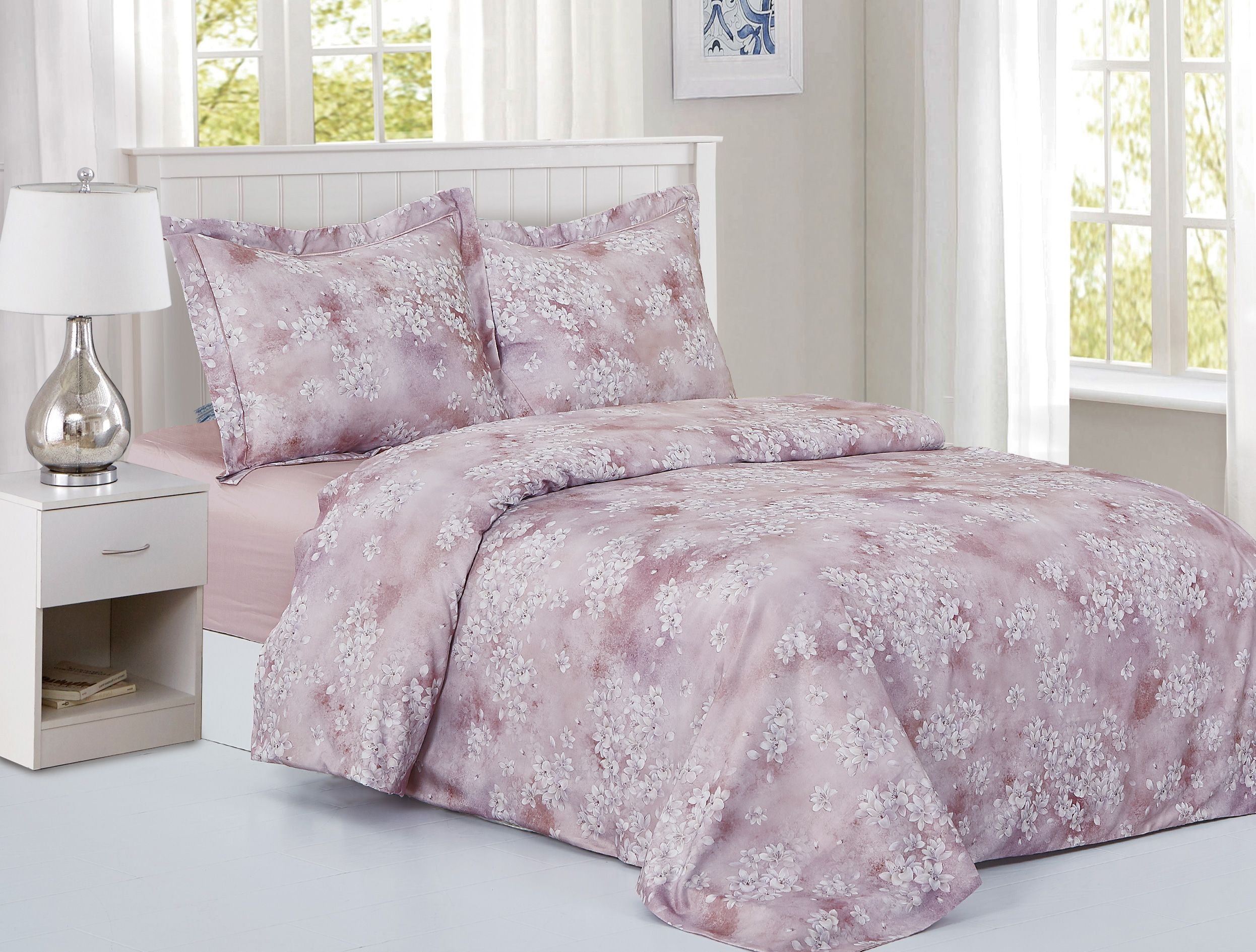 Mauve cotton sateen duvet set clustered with white magnolia blossoms, with matching shams