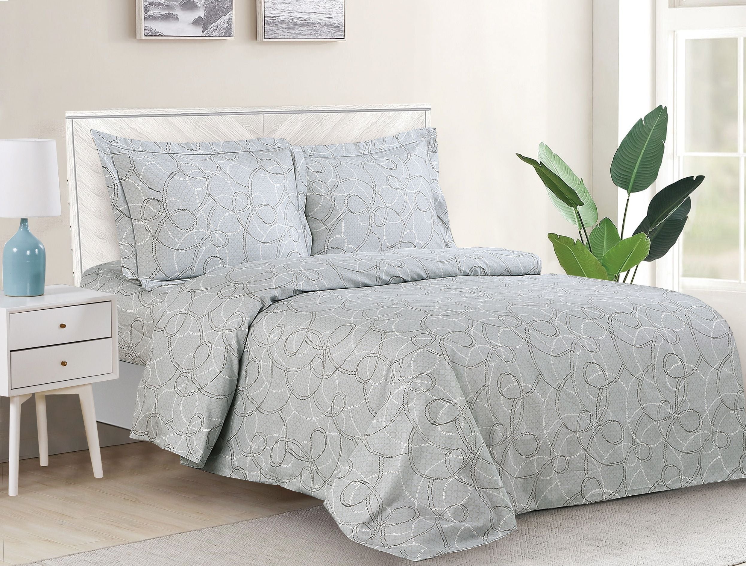 Grey duvet set with a white scrolling-swirl pattern and matching shams on a bed
