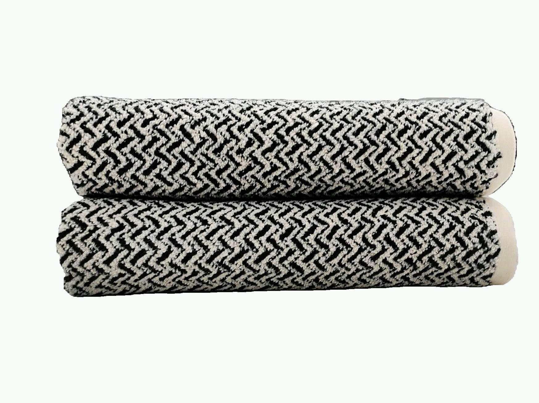 Black and white woven chevron zigzag terry towels, rolled and stacked
