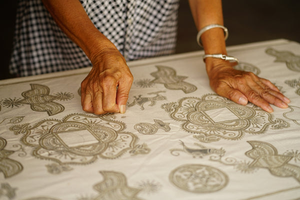Handcrafted tablecloth featuring intricate gray embroidery patterns and floral designs.