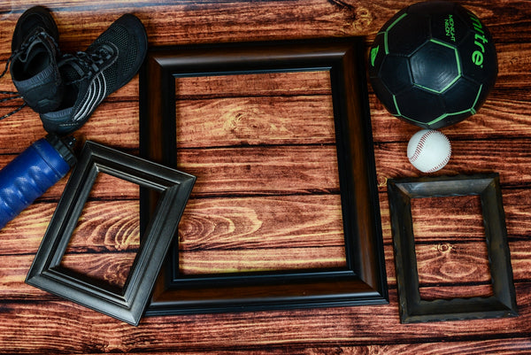 Sporting Goods Display featuring black frames, a soccer ball, baseball, and athletic shoes.