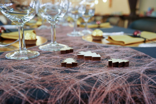 Decorative chocolate puzzle pieces on a festive table setting with glasses and gold accents.