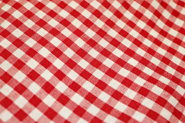 Red Gingham Tablecloth featuring a classic checkered pattern for dining.