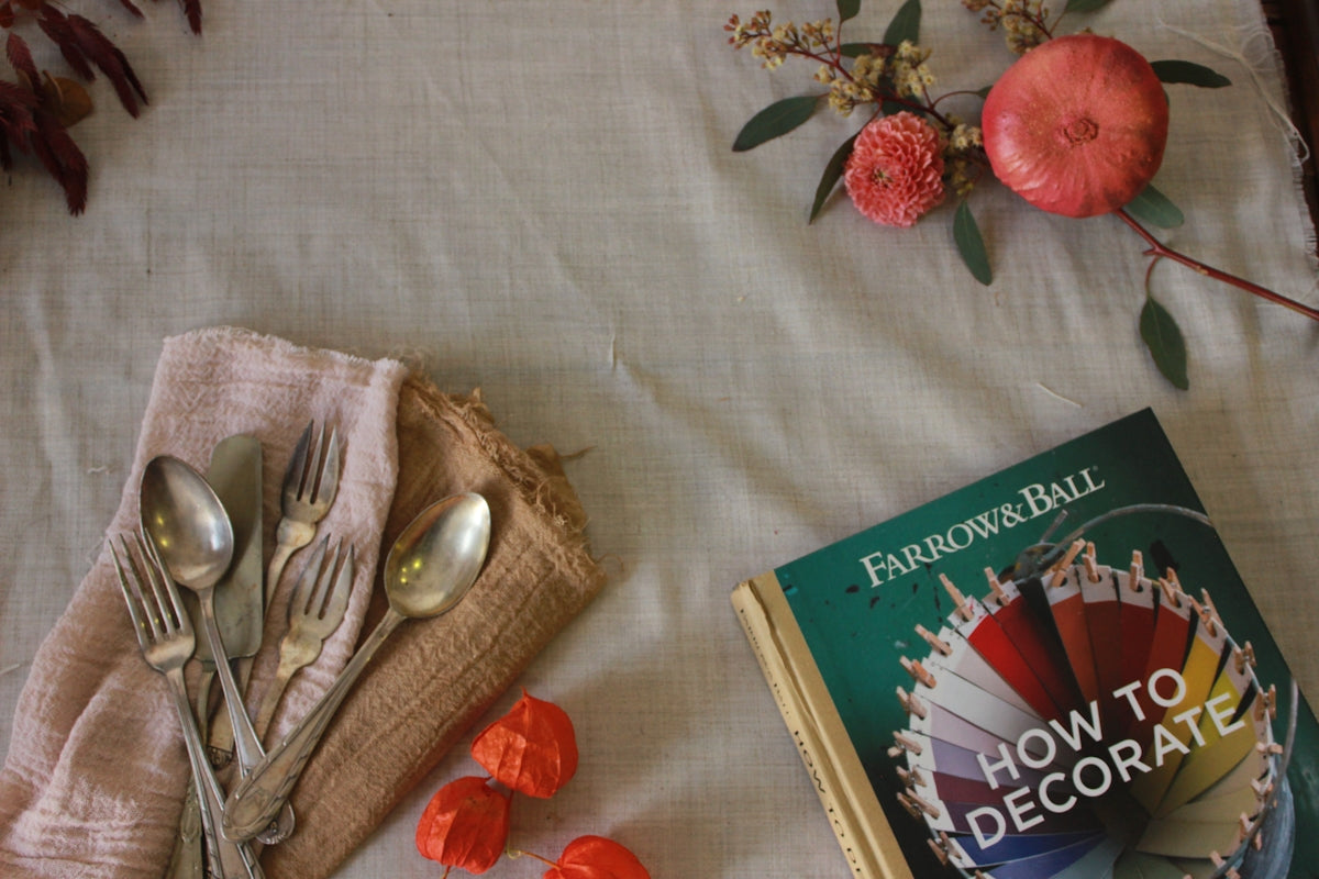 How to Decorate book by Fairchild Ball with silver spoons and decorative elements on a table.