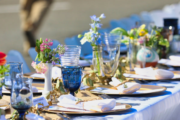 Elegant table setting with colorful glassware and fresh flowers for a special event.