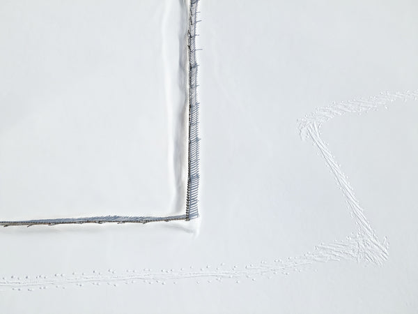 Product image featuring a textured white surface with subtle gray stitching details.