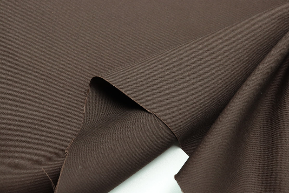 Brown Cotton Fabric with a smooth texture and drape.