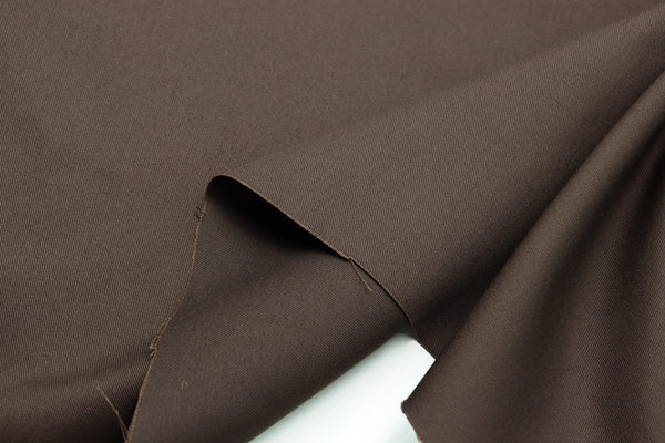 Brown Cotton Fabric with a smooth texture and drape.