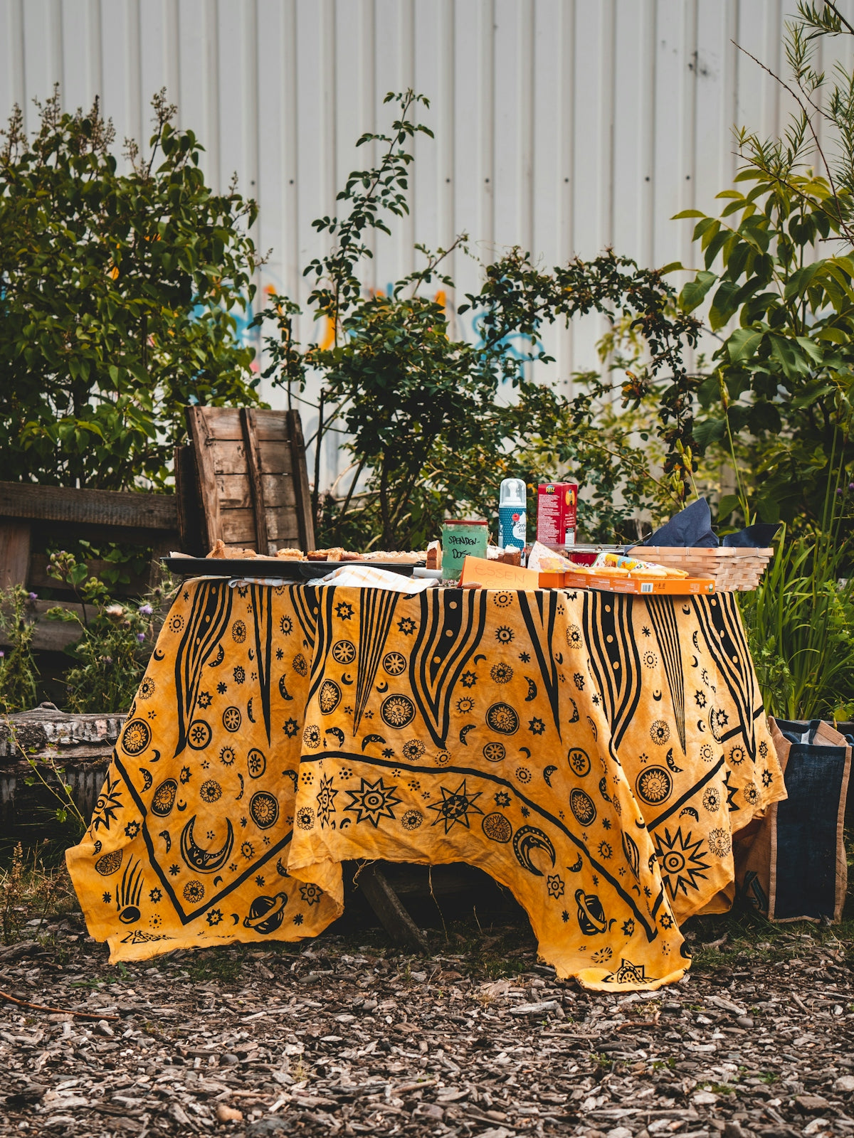 Yellow patterned tablecloth featuring intricate designs, perfect for outdoor dining.