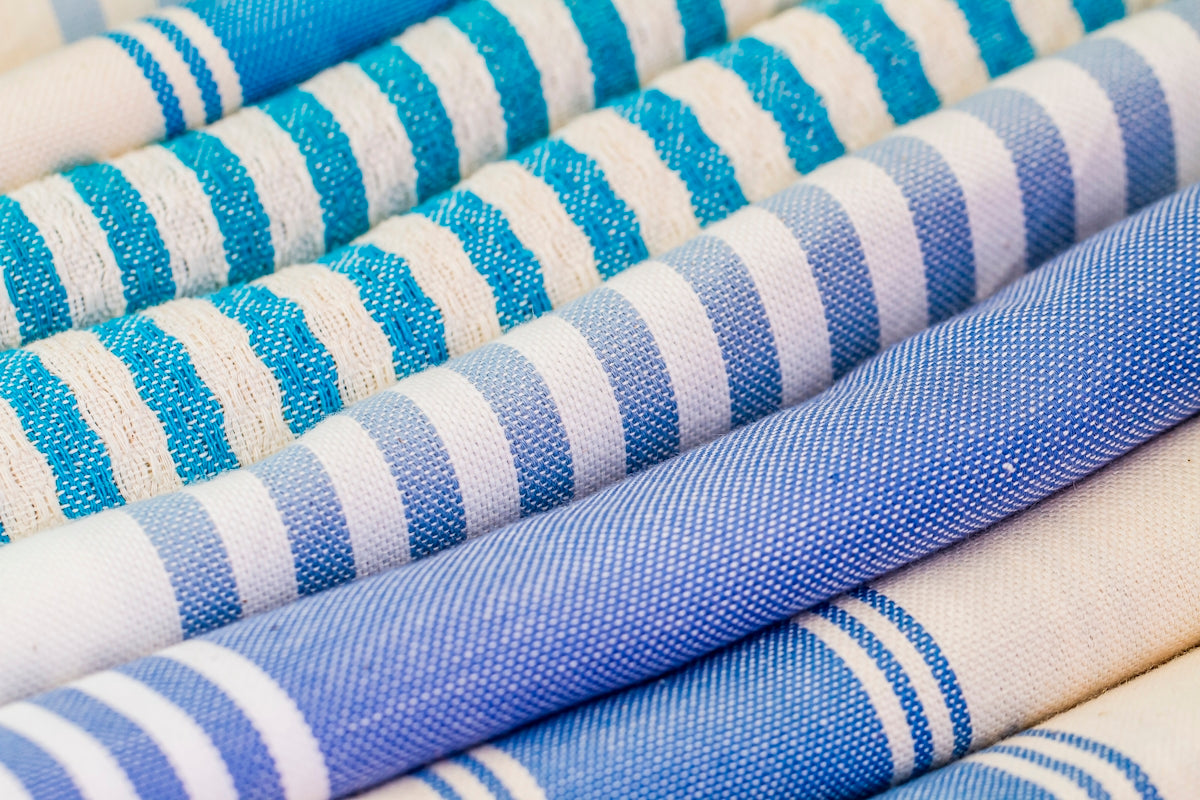 Blue Striped Fabric showcasing various shades and patterns in a rolled arrangement.