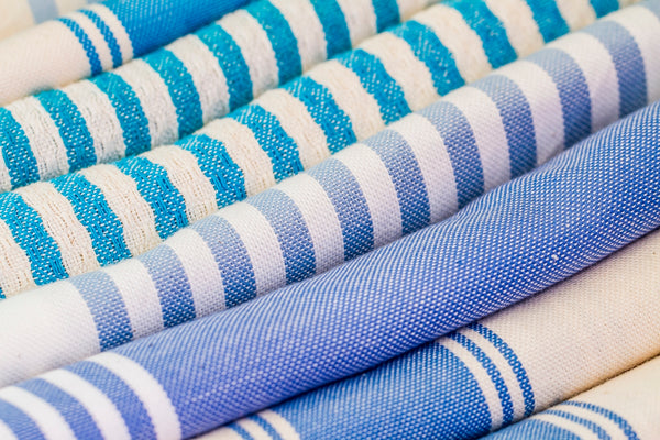 Blue Striped Fabric showcasing various shades and patterns in a rolled arrangement.