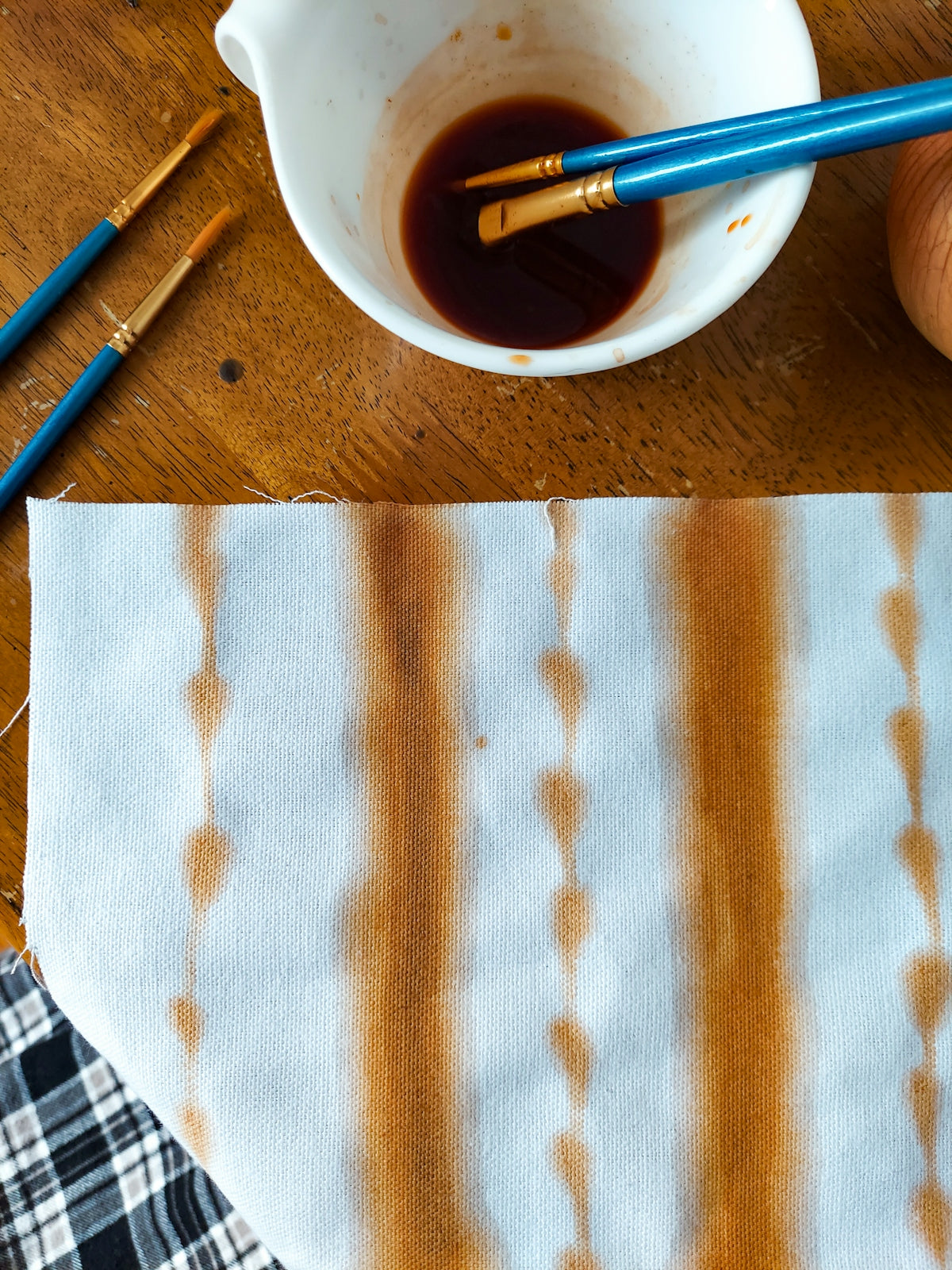 Fabric with orange and white stripes, ideal for crafting projects.