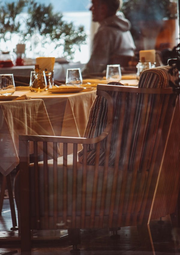 Dining chair with striped cushion in a restaurant setting.