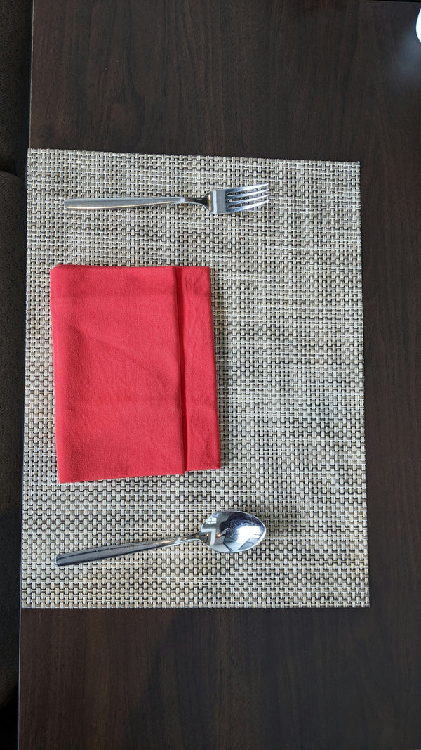 Red Napkin on Woven Placemats with Fork and Spoon.