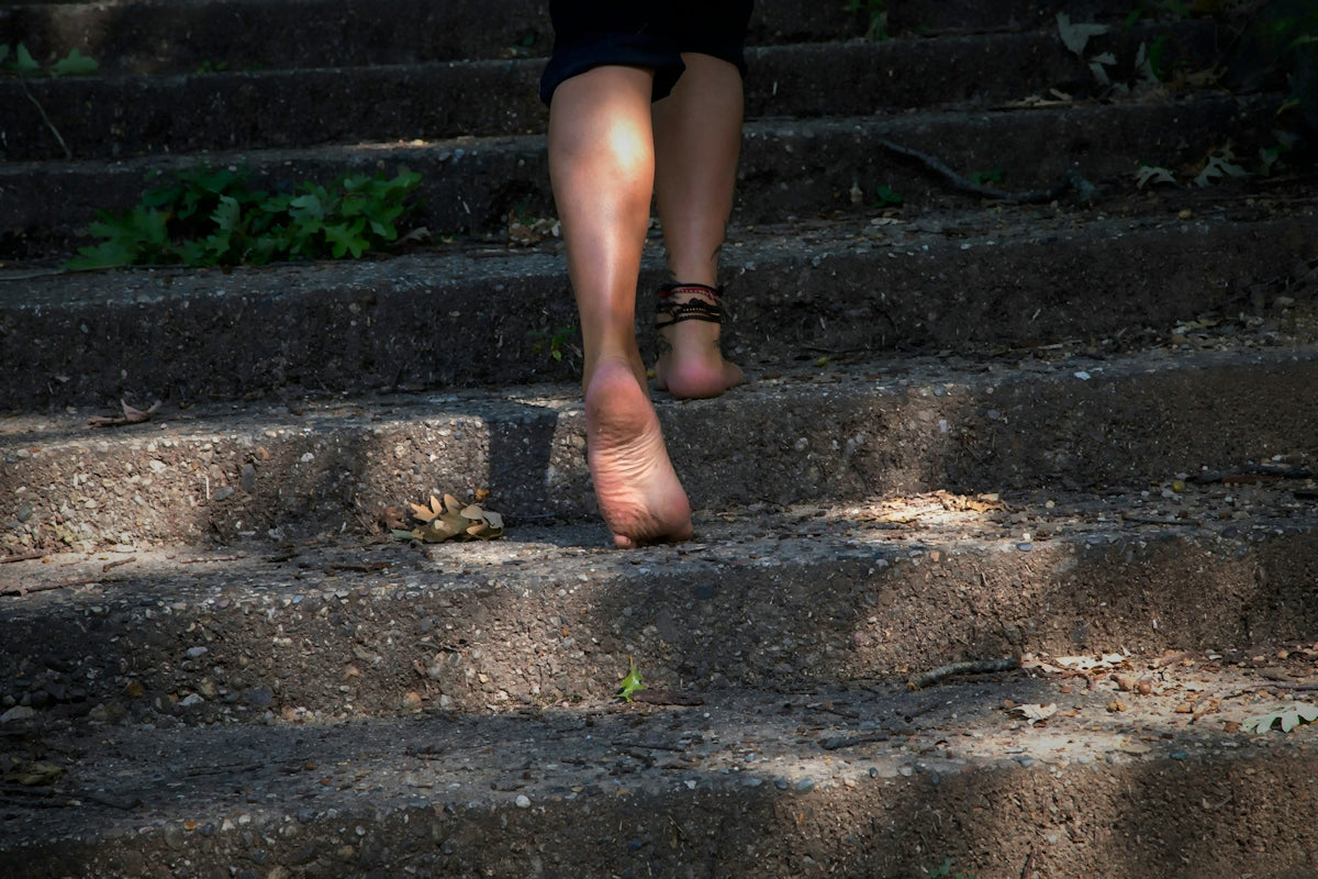 A woman walking up some steps with her shoes on