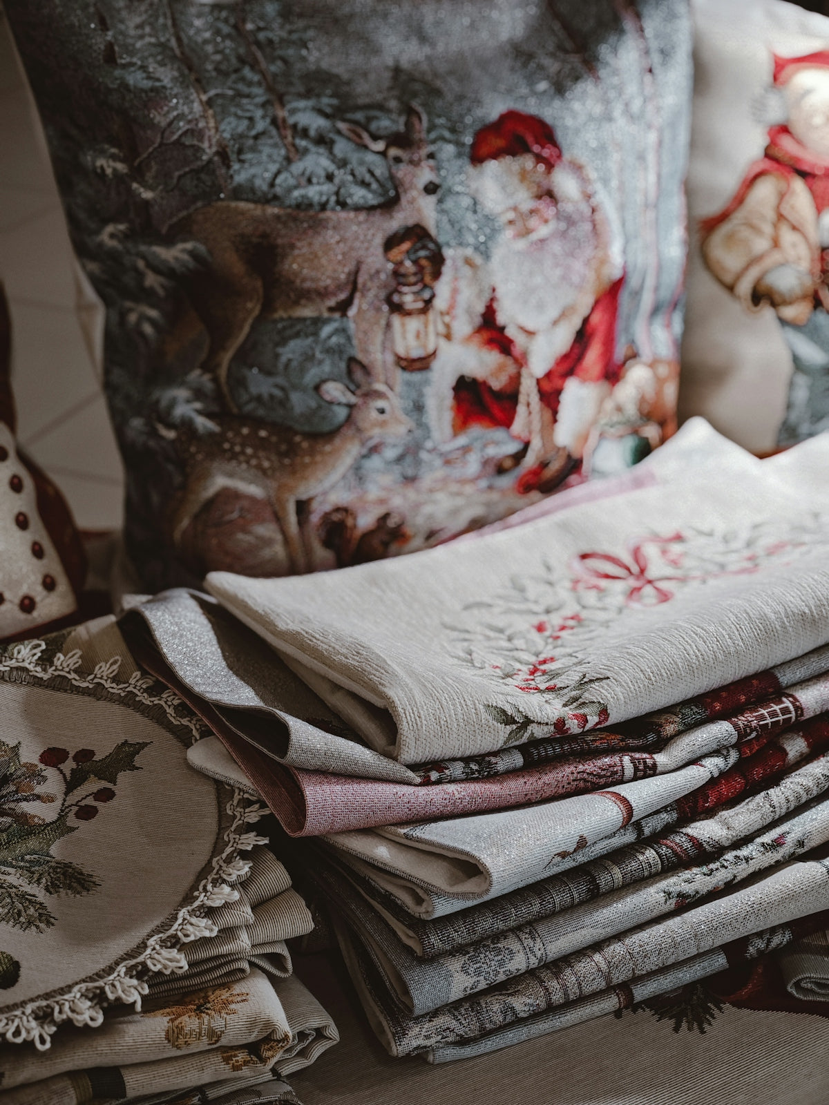Christmas-themed pillows and folded napkins arranged nicely.