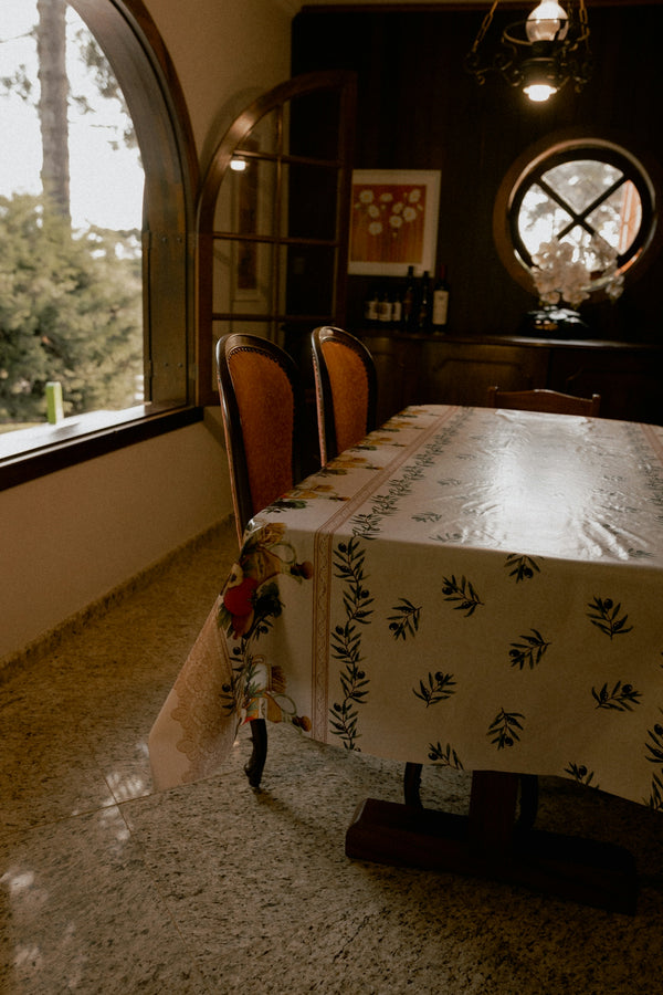 Dining table with patterned tablecloth and arched window