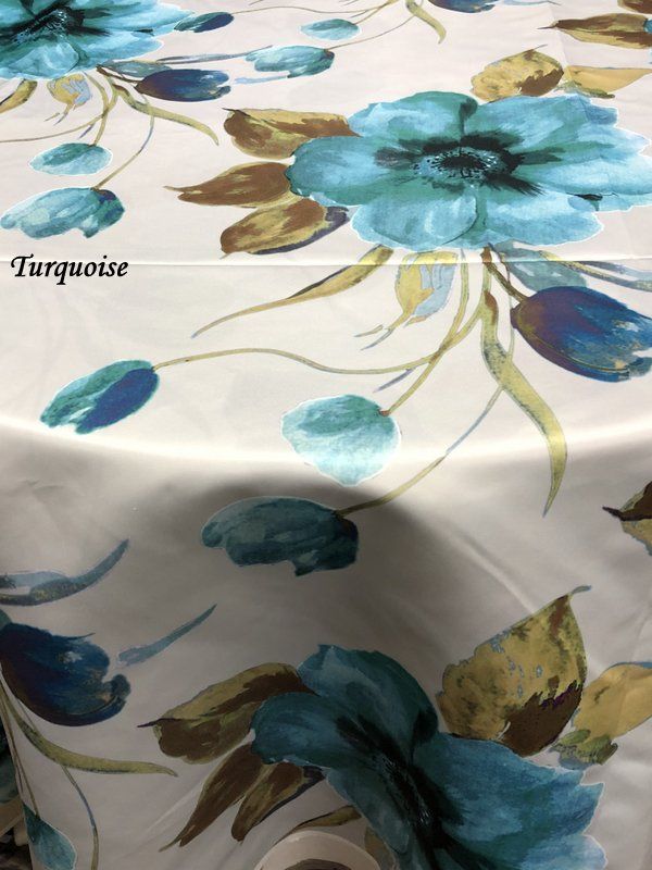 Turquoise Floral Tablecloth featuring vibrant blue flowers and green leaves on a white background.