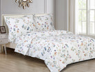 White cotton duvet set printed with watercolour ginkgo leaves in green, blue and peach, with matching shams