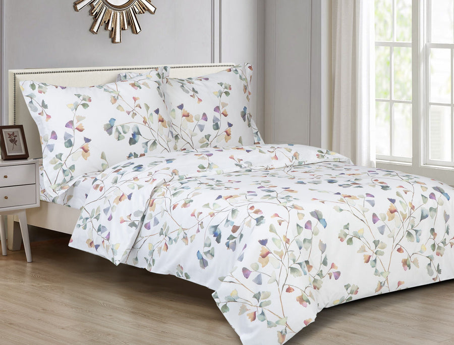 White cotton duvet set printed with watercolour ginkgo leaves in green, blue and peach, with matching shams